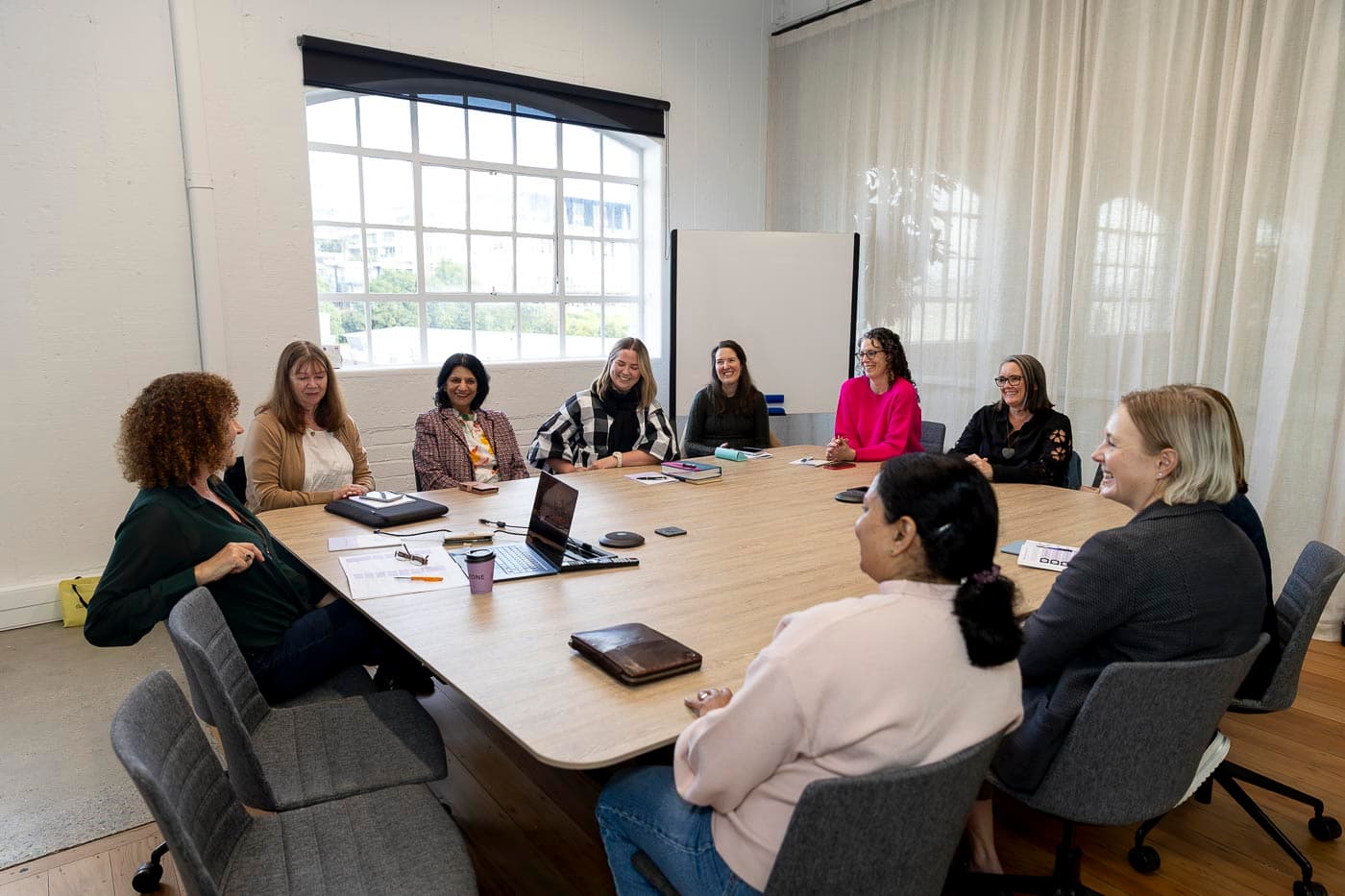 A homegroup meeting, members round the table together